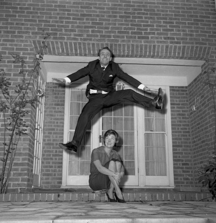 Dickie leaping over Dixie at home in Kensington on his 37th birthday, 1959.