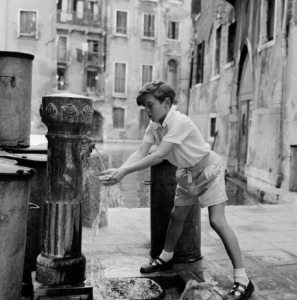 David Hemmings, aged 12 enjoying Venice (drinking water from a fountain) between rehearsals of Benjamin Britten's new opera 'Turn of the Screw".