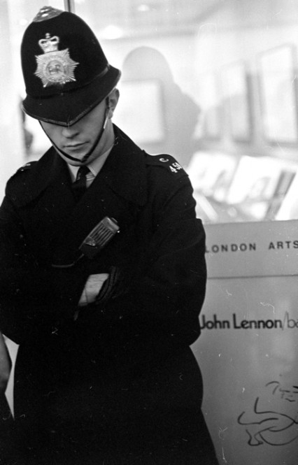 A police at duty outside Lennon's Bag One exhibition at London Arts gallery 1970